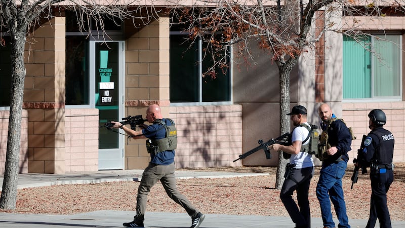 FILE - Law enforcement officers head into the University of Nevada, Las Vegas, campus after...