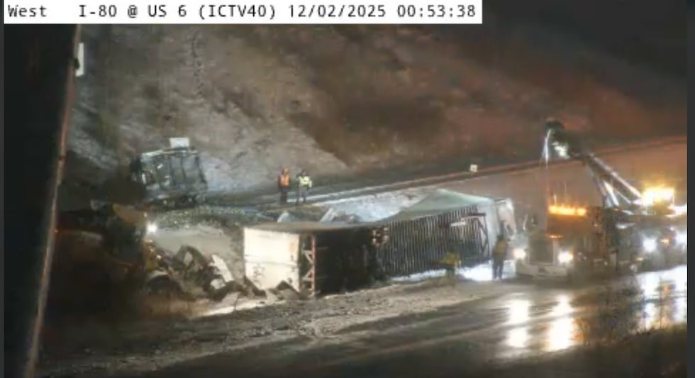 Emergency crews can be seen around a semi-trailer Tuesday morning.