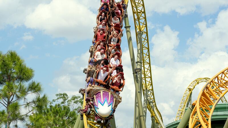 FILE - Guests ride on the Stardust Racers roller coaster at Epic Universe Theme Park at...