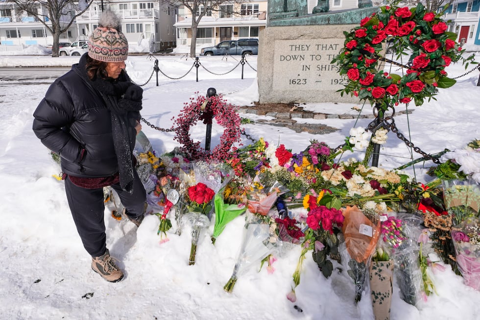 Christine Porper of Gloucester, Mass. pauses at the fisherman's memorial near the homeport of...