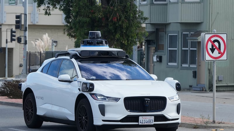 A Waymo vehicle drives past a No U-Turn sign in San Bruno, Calif., Tuesday, Sept. 30, 2025....